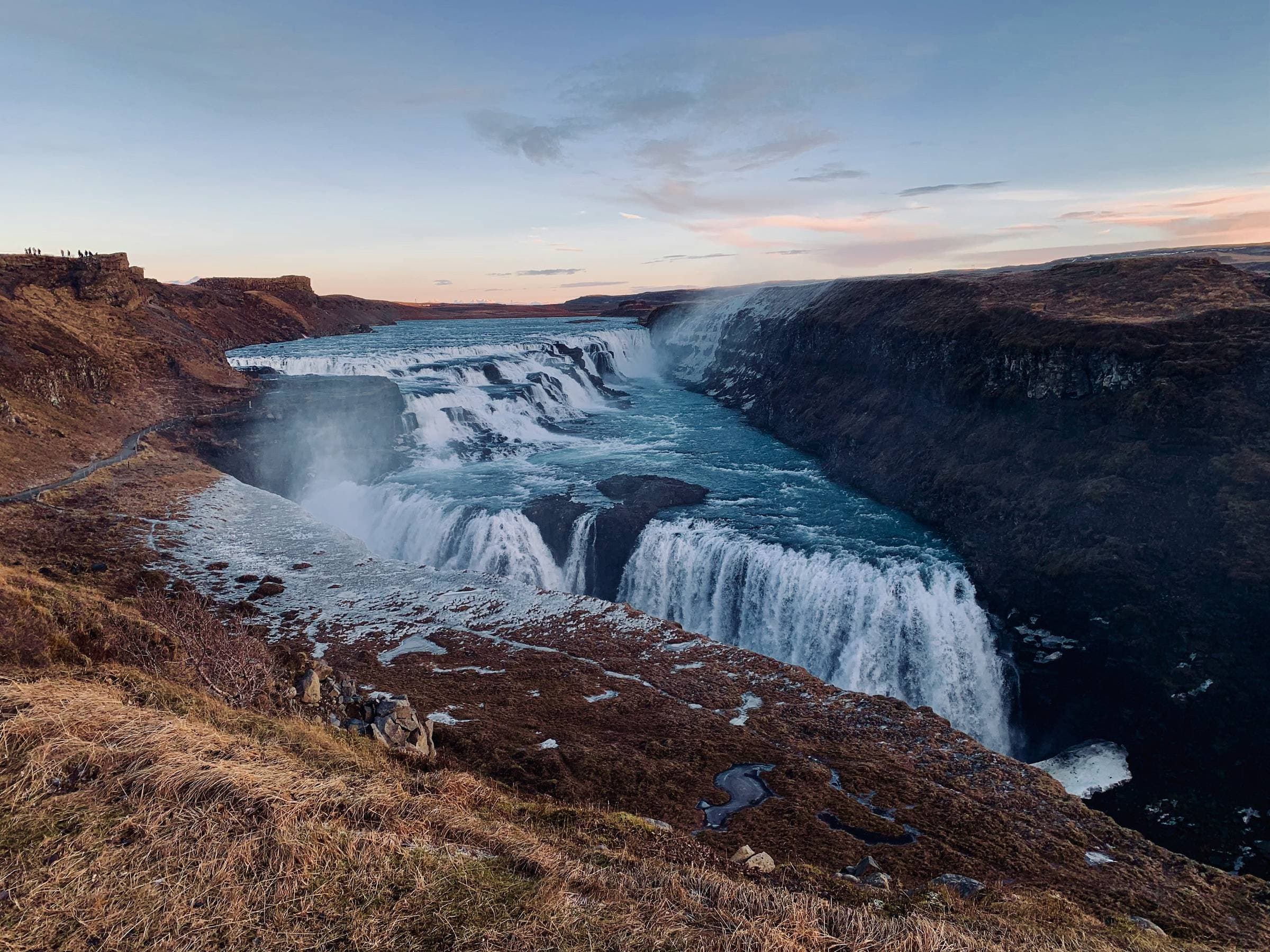 Gullfoss waterfall, where glacial water from the Hvítá river plunges into a rugged canyon in one of Iceland’s most iconic natural sights.