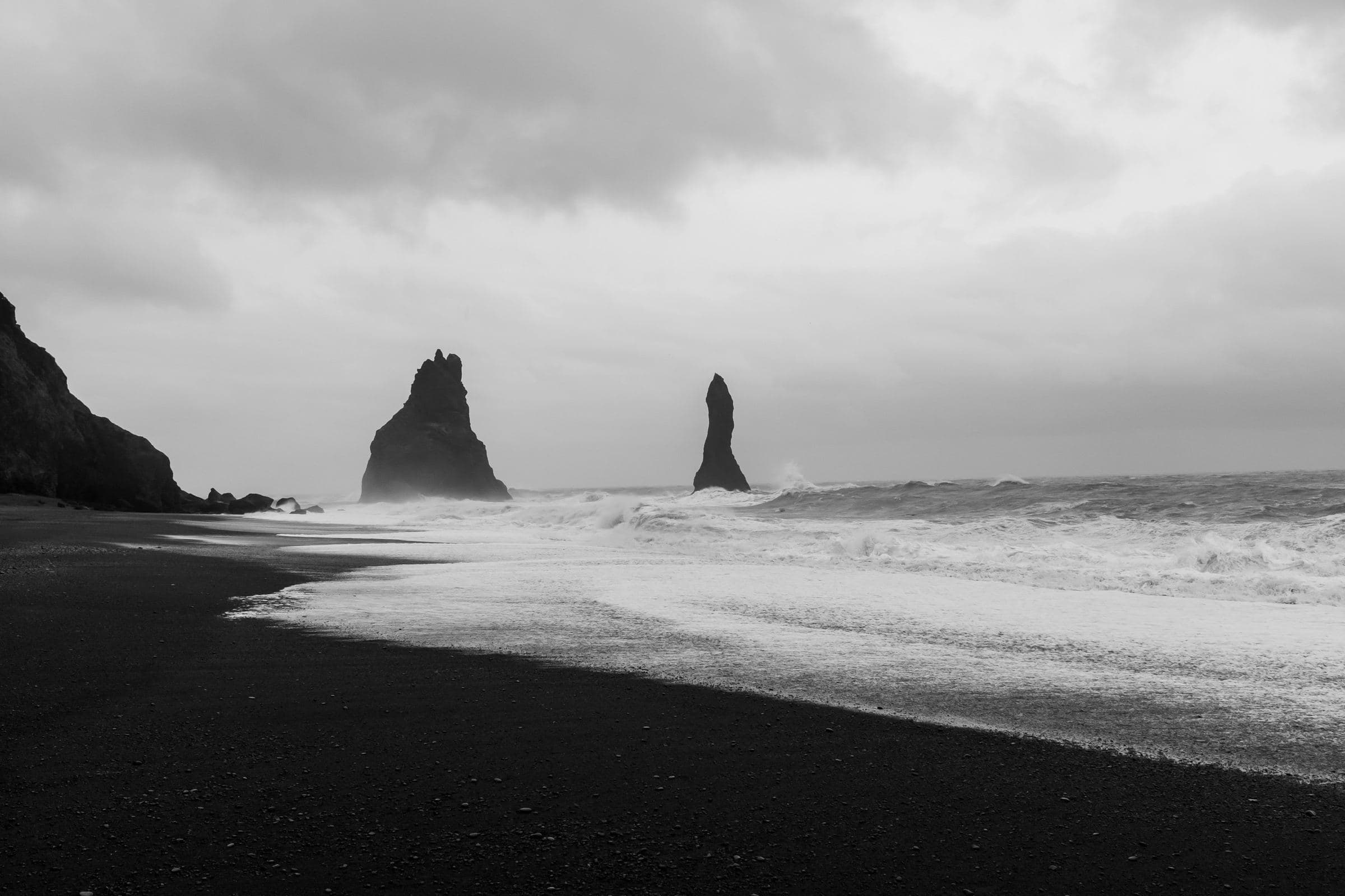 Reynisfjara Black Sand Beach, known for its volcanic sand, basalt columns, and Atlantic waves.